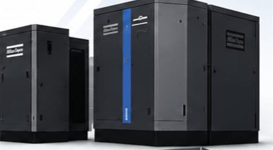 Two Atlas Copco rotary screw air compressor packages in enclosed cabinets.